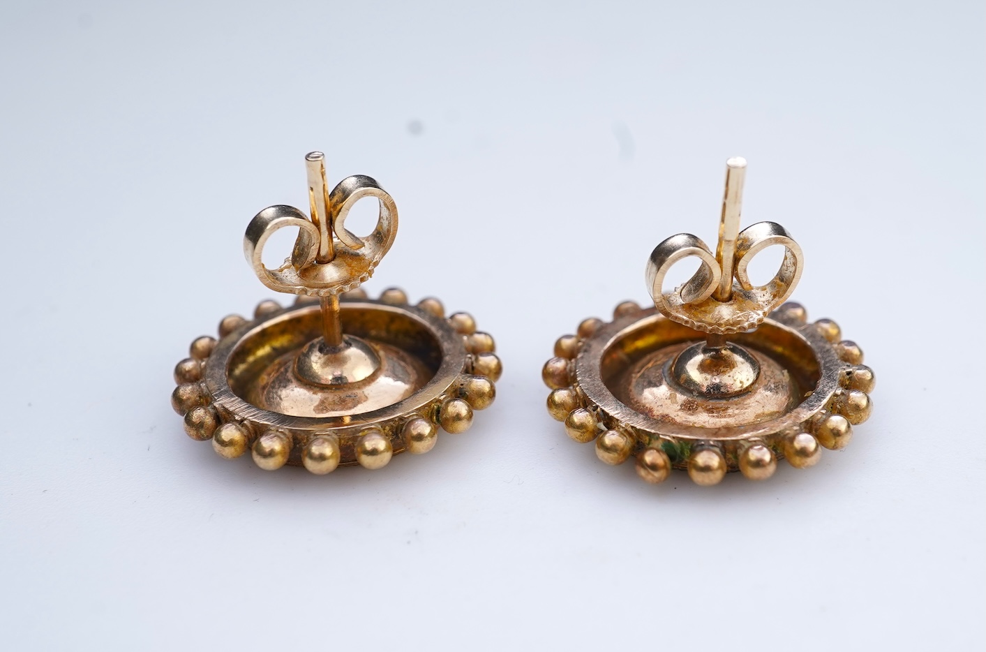 A gold, enamel and pearl pendant/brooch, mid 19th century, and a pair of earrings